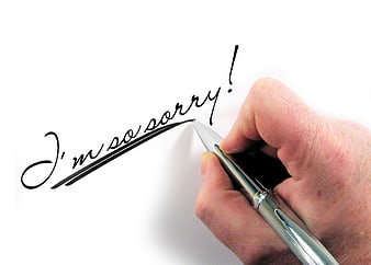 Hand Writing I'm So Sorry with Pen on White Paper