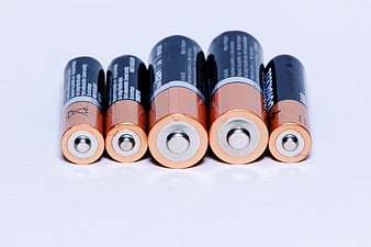Assorted AA and AAA batteries on white background