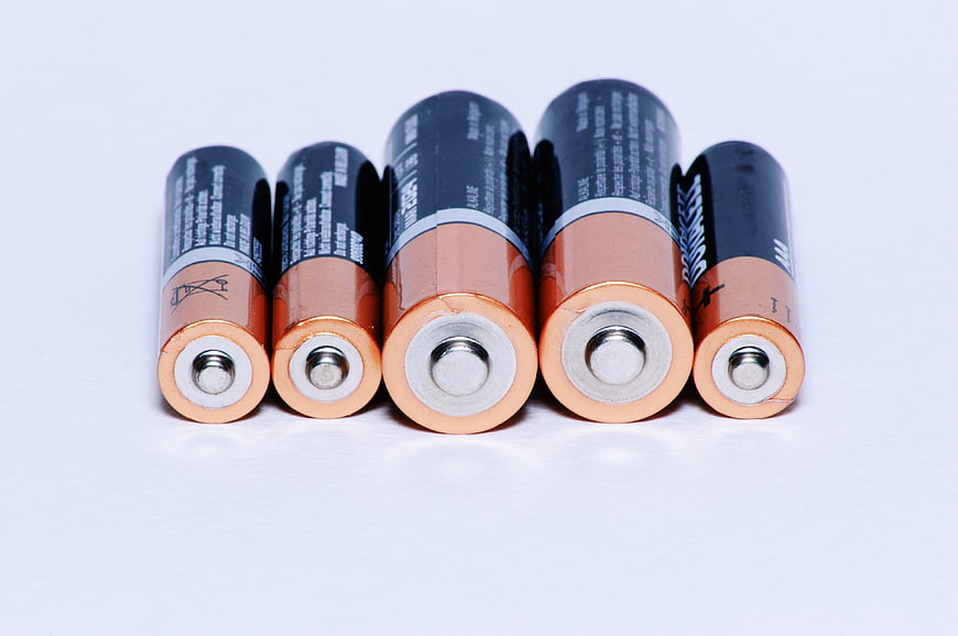 Assorted AA and AAA batteries on white background