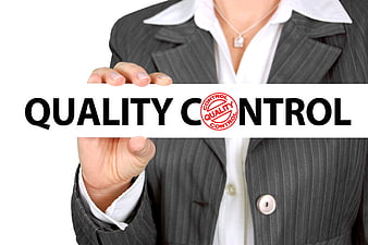 Businesswoman holding quality control sign with stamp