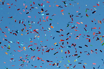 Colorful Confetti Falling Against Blue Background