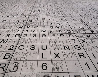Close-up of a handwritten alphanumeric grid puzzle on paper