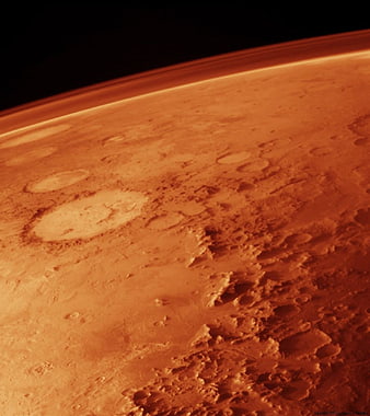 Aerial view of Mars surface with craters and atmosphere