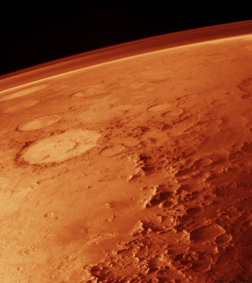 Aerial view of Mars surface with craters and atmosphere