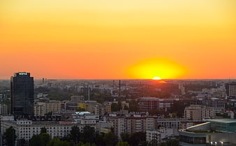 Vibrant Orange Sunset Over Warsaw City Skyline