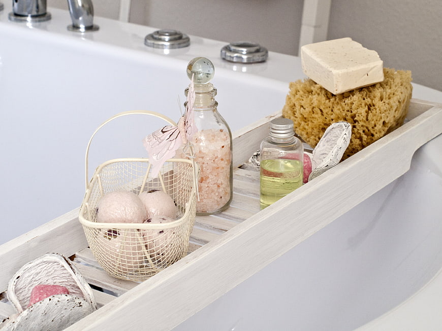 Bath accessories on wooden tray with spa products