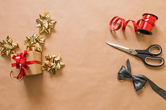 Christmas gift wrapping supplies on kraft paper background