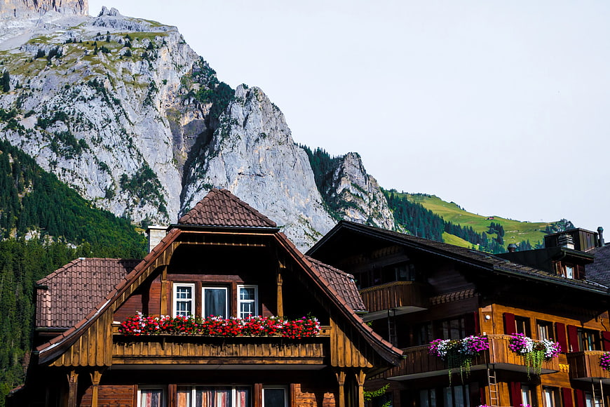 Traditional Alpine Chalet with Flower Boxes Against Mountain