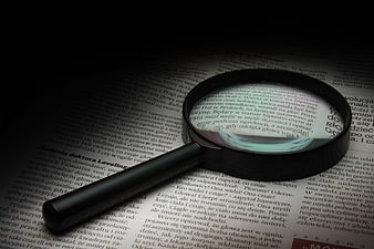 Magnifying glass on open book page with Polish text