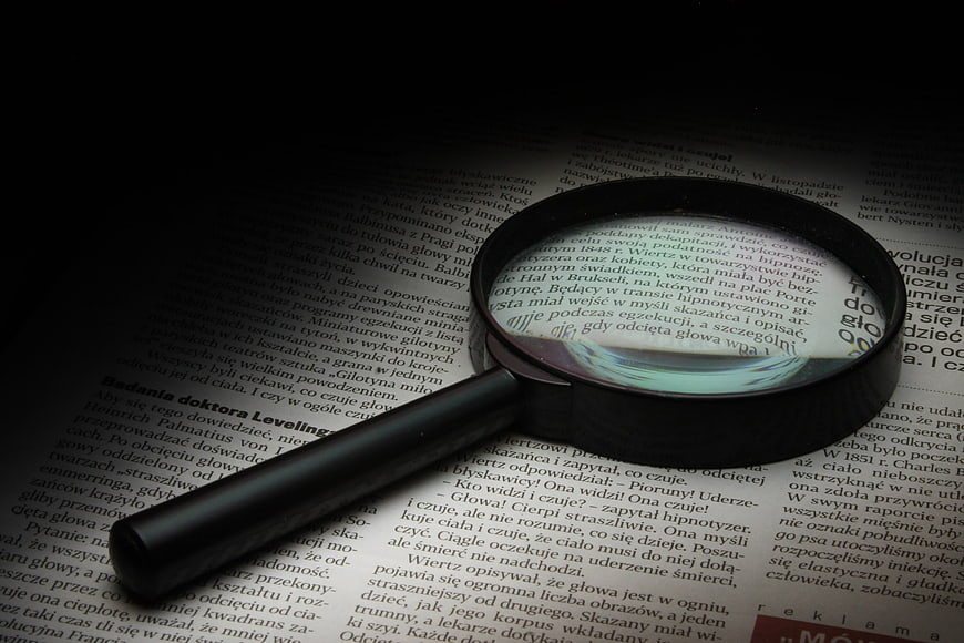 Magnifying glass on open book page with Polish text