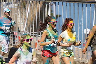 Runners Covered in Colorful Powder at a Fun Run Event
