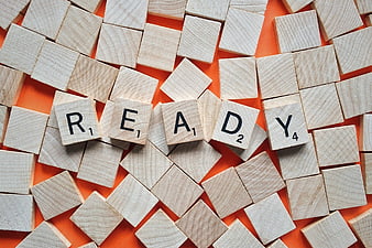 Scrabble Tiles Spelling Ready on Orange Background