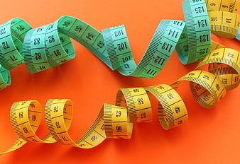 Green and Yellow Tailor's Measuring Tapes on Orange Background