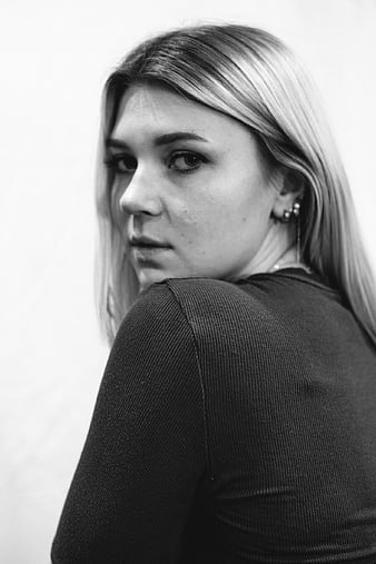 Black and white portrait of young woman looking over shoulder