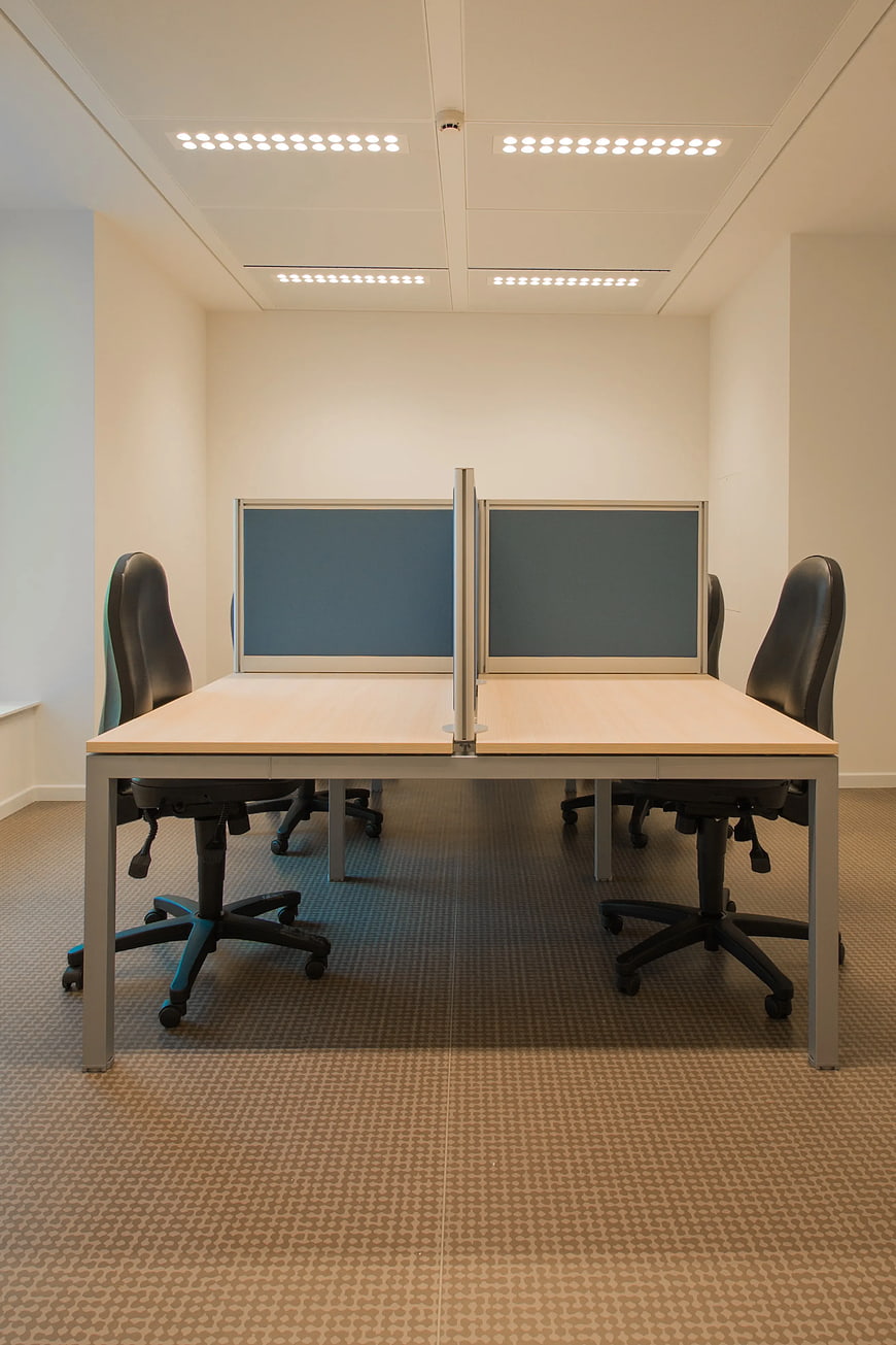 Modern office workspace with desks and chairs