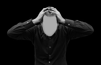 Stressed man holding head in black and white studio portrait