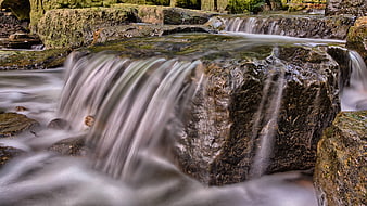 Long Exposure Waterfall Flowing Over Mossy Rocks