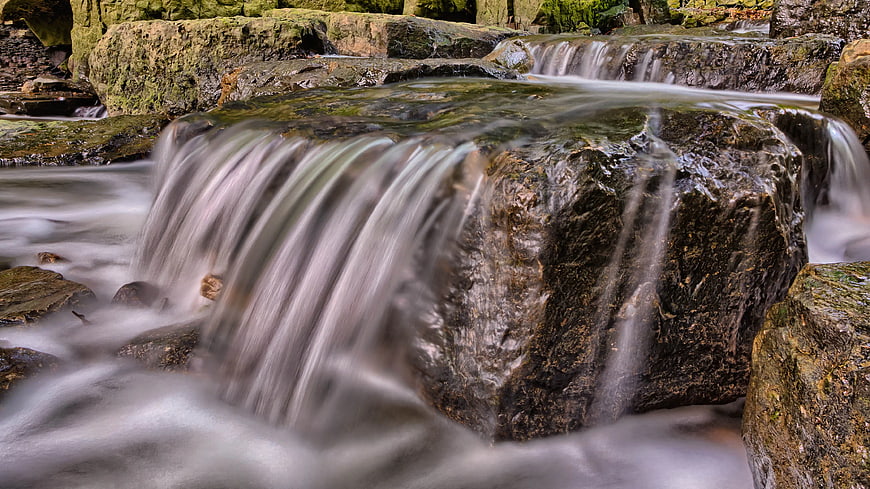 Long Exposure Waterfall Flowing Over Mossy Rocks