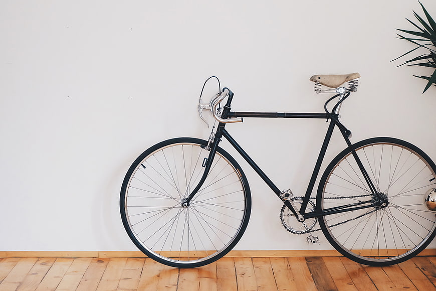 Vintage Black Bicycle Leaning Against White Wall