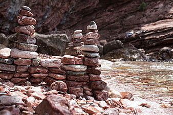 Stacked river stones by flowing water