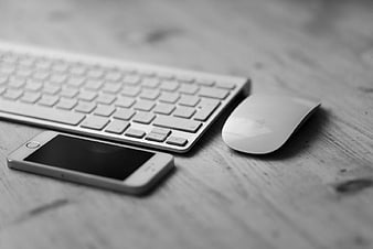 Black and White Workspace with Keyboard, Mouse, and Smartphone