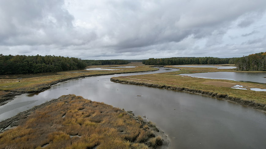 Aerial View of Winding River Through Marshland