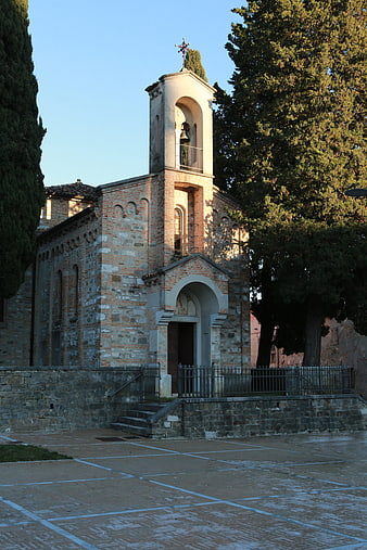 Historic brick church with bell tower and stone steps