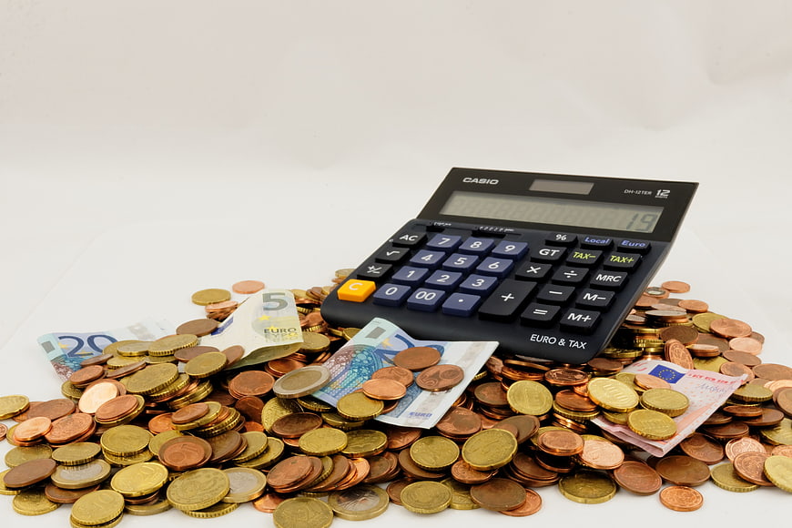 Pile of Euro Coins and Banknotes with Calculator