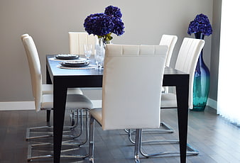 Modern Dining Room With Black Table And White Leather Chairs