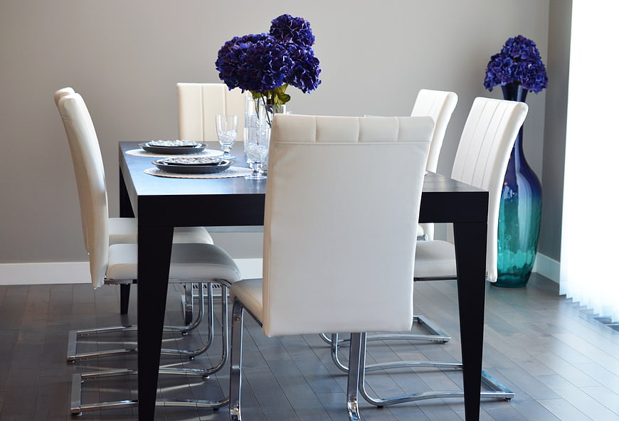 Modern Dining Room With Black Table And White Leather Chairs