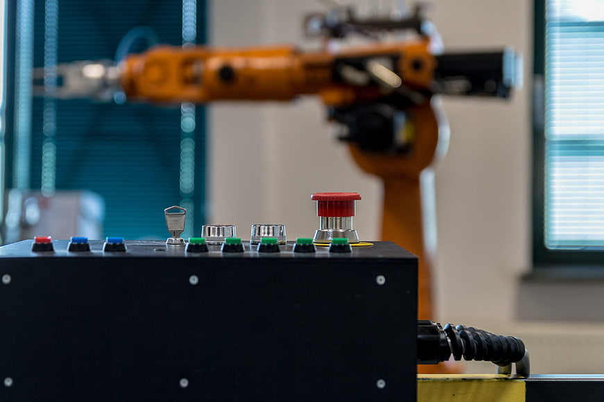 Industrial Robot Arm and Control Panel in Factory