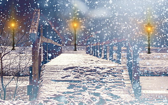 Snowy wooden bridge path with glowing street lamps in winter