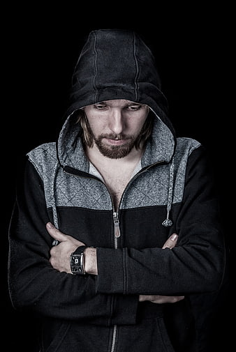 Portrait of a man in a black hoodie with crossed arms