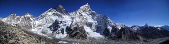 Panoramic View of Snow-Capped Himalayan Peaks Under Blue Sky