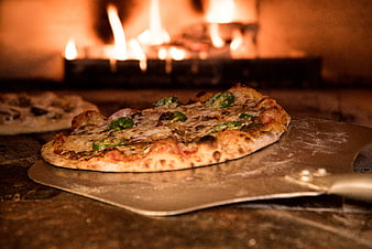 Freshly Baked Pizza on Metal Peel in Wood-Fired Oven