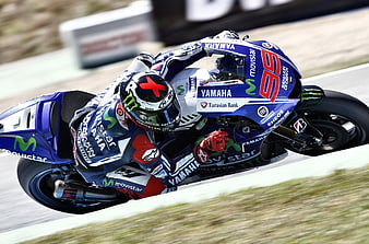 MotoGP racer leaning into a curve on a Yamaha motorcycle