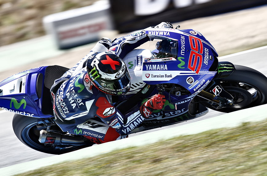 MotoGP racer leaning into a curve on a Yamaha motorcycle