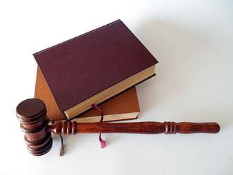 Wooden Gavel and Law Books on White Background