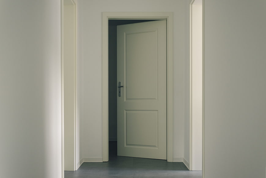 Minimalist Interior Hallway with Open White Door