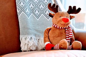 Cute Plush Reindeer Toy on Sofa with Christmas Scarf