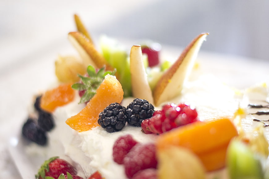 Close-up of fresh fruit dessert with berries and cream