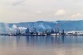 Oil refinery industrial complex on the coast with smokestacks