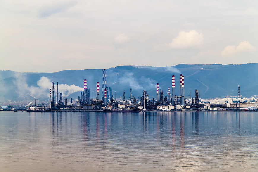 Oil refinery industrial complex on the coast with smokestacks