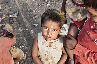 Portrait of a young child in a dusty urban environment