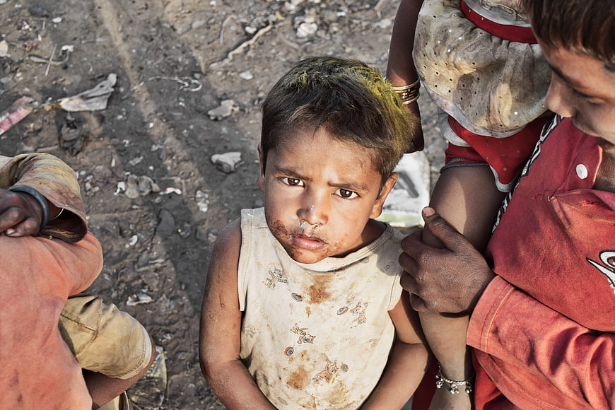 Portrait of a young child in a dusty urban environment