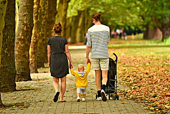 Family Walking Together In Autumn Park