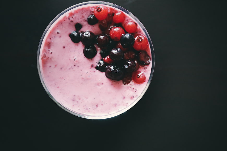 Top View Berry Smoothie with Fresh Fruit on Dark Background