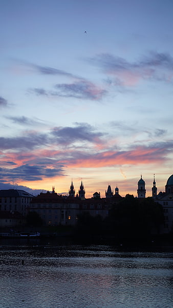 Prague skyline silhouette at sunset over the Vltava River