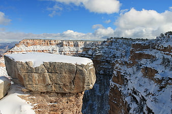 Snow-Covered Canyon Cliff with Blue Sky