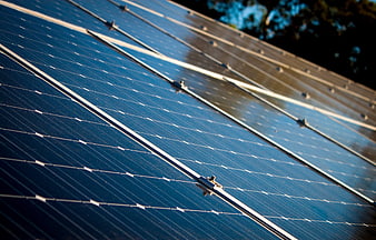 Close-up of blue solar panels with sunlight reflection